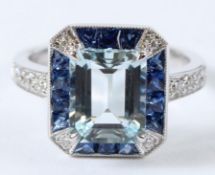 AN 18CT WHITE GOLD AQUAMARINE, SAPPHIRE AND DIAMOND RING 2ct 7. Size O.