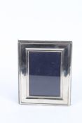 A PLAIN SILVER PHOTOGRAPH FRAME. 13cms x 9cms.