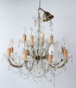 AN ORNATE TWO TIER TWELVE LIGHT CANDELABRA, without glass prisms and drops. 57cms diameter x 42cms