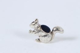 A SILVER SQUIRREL PIN CUSHION.