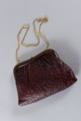 A VINTAGE COPPOLA E TOPPO, MILAN, SOFT LEATHER BAG with gilt metal strap. 26cms long.