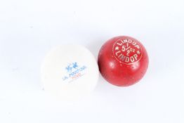 TWO POLO BALLS, a red Lindop 5 1/2 ozs and a white La Martina.