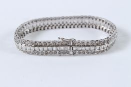 A GOOD 18CT WHITE GOLD TRIPLE ROW DIAMOND BRACELET. 32grams.