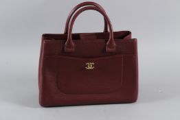 A VERY GOOD CHANEL RED LEATHER BAG with inner purse, gilt double C and plain handles. 34cms long,
