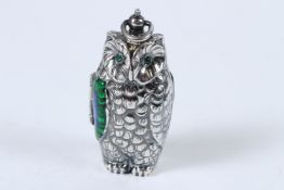 A SILVER PLATED EMERALD EYE OWL SOVEREIGN CASE.