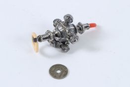 A CORAL HANDLED RATTLE/