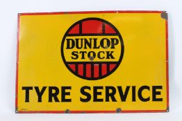 A VINTAGE DUNLOP STOCK TYRE SERVICE ENAMEL SIGN. 50cms x 80cms.
