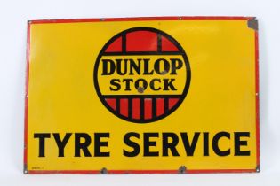 A VINTAGE DUNLOP STOCK TYRE SERVICE ENAMEL SIGN. 50cms x 80cms.
