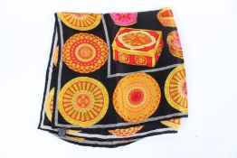 A GIANNI VERSACE SCARF in original box.