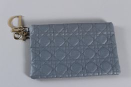 A CHRISTIAN DIOR GREY PADDED LEATHER BAG with zip, Dior gilt letters. 25cms long, with dust cover.