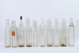 NINE ESSO LUBE GLASS OIL BOTTLES and a SHELL MOTOR OIL BOTTLE.