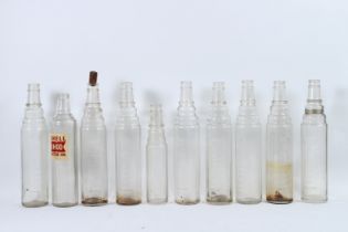 NINE ESSO LUBE GLASS OIL BOTTLES and a SHELL MOTOR OIL BOTTLE.