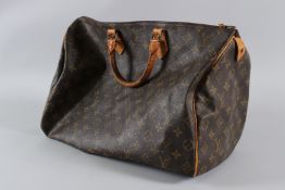 A LOUIS VUITTON LEATHER BAG with zip and plain handles. 40cms long, with dust cover. Sold with