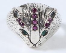 A SILVER RUBY AND EMERALD CAT HEAD RING.