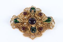 A LARGE CHANEL PIERCED GILT OVAL BROOCH set with eight cabochon stones. 9cms long x 7cms wide.