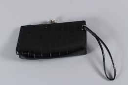 A BURBERRY BLACK LEATHER PURSE. 19cms long.