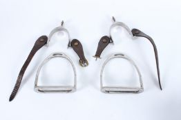 A PAIR OF CHROME AND LEATHER STIRRUPS.