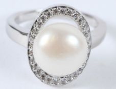 A SILVER AND PEARL RING.