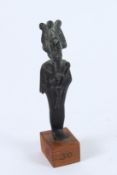 AN ANCIENT BRONZE STATUE of the Egyptian god OSIRIS, god of the underworld, on a wooden base.