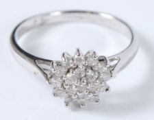 A 9CT GOLD DIAMOND CLUSTER RING.