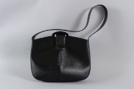 A LOUIS VUITTON BLACK LEATHER RIBBED BAG with plain handle. 28cms long, with dust cover. Sold with