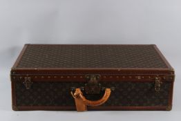 A LARGE LOUIS VUITTON SUITCASE No. 79670. 80cms long x 50cms wide x 20cms deep.