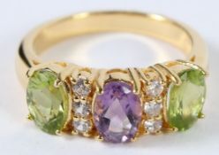 A SILVER GOLD PLATED PERIDOT AND AMETHYST RING.