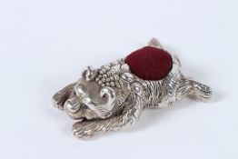 A SILVER BEAR PIN CUSHION.