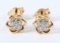 A PAIR OF 18CT YELLOW GOLD DIAMOND CLUSTER EAR STUDS.