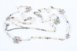 A LONG VINTAGE CHANEL PEARL NECKLACE with eight double C's.