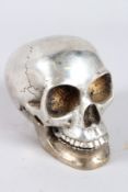 A SILVER PLATED SKULL. 3.5ins high