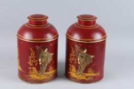 A PAIR OF CHINESE DESIGN TOLEWARE TEA JARS AND COVERS. 14ins high