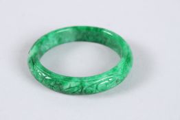 A CHINESE CARVED JADE BANGLE. 2.5ins diameter. 32 grams