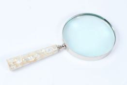 A LARGE MAGNIFYING GLASS.
