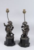 A PAIR OF CHERUB LAMPS on octagonal bases. 16ins high