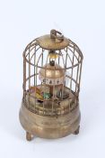 A BIRD CAGE STYLE CLOCK.