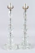 A PAIR OF CUT GLASS LAMPS on octagonal bases. 20ins high