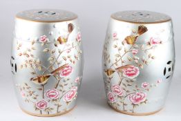 A PAIR OF SILVERED PORCELAIN FLORAL BARREL SEATS. 18ins high