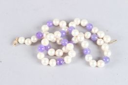 A 14CT GOLD AND LAVENDER JADE NECKLACE. 18ins long