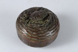A BRONZE CIRCULAR BOX AND LID, the top with a crab. 8cms diameter