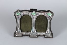 A SMALL SILVER AND ENAMEL ART NOUVEAU PHOTOGRAPH FRAME. 7cms x 10cms