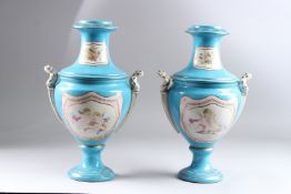 A PAIR OF SEVRES STYLE PORCELAIN TWIN HANDLED PEDESTAL VASES, blue ground, decorated with panels