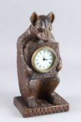 A BLACK FOREST STYLE CARVED WOOD BEAR MANTLE CLOCK. 12ins high