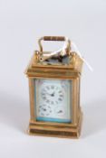 A FRENCH THREE-DIAL MINIATURE CARRIAGE CLOCK with porcelain panels. 3ins high