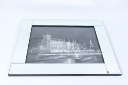 A MIRRORED FRAMED DECORATIVE PRINT OF PARIS AT NIGHT.