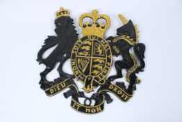 A CAST METAL COAT OF ARMS.