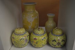 A set of three Chinese famille jaune ginger jars and covers and two Chinese vases.
