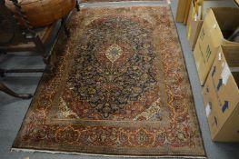 A Persian carpet, blue ground with stylised floral decoration, signed, 220cm x 145cm.