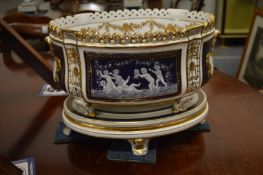A good large pair of Continental porcelain oval jardinieres and stands, gilt decorated with panels