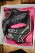 A pair of Gina black leather boots, size 6.